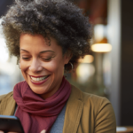 Woman happy looking at her phone after making a claim for lost property